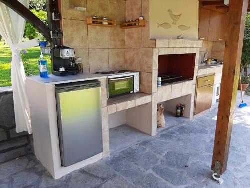 a kitchen with a stove and a microwave at Latoura Studios in Ormos Panagias