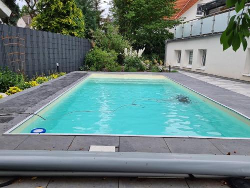 a swimming pool in the backyard of a house at Haus Koch in Niestetal