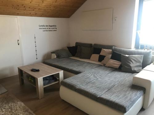 a living room with a couch and a table at Schanzenblick in Winterberg
