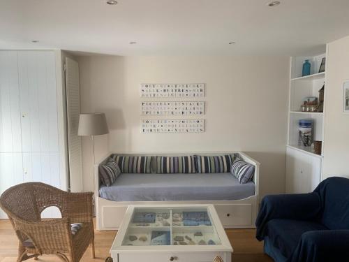 a living room with a bed and a table at vue sur mer in Cancale