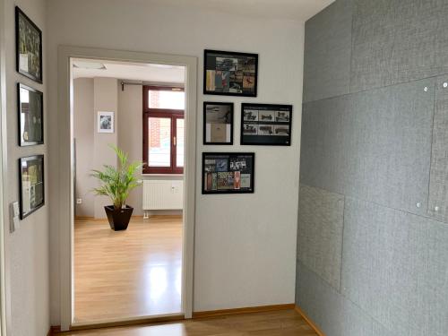 a hallway with a door with pictures on the wall at Charmante Dachgeschoss Wohnung in Leipzig