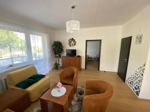 a living room with a couch and a table at Apartments Monty Podhájska in Podhájska