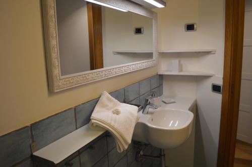 a bathroom with a sink and a mirror at CriSè Home in Naples
