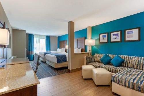a hotel room with a couch and a bed at Comfort Suites of Las Cruces I-25 North in Las Cruces