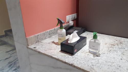 a bird sitting on a counter with two bottles of wine at HOTEL DELTA ATLAS in Casablanca