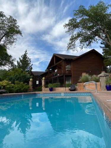 a large swimming pool in front of a house at Flanigan`s Resort and Spa in Springdale