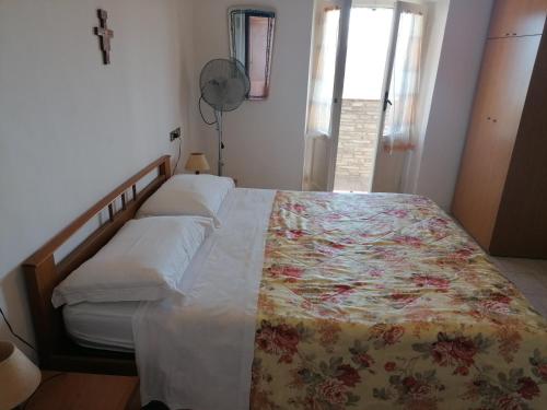 a bedroom with a bed with a floral bedspread at Camere da Anna Maria in Assisi