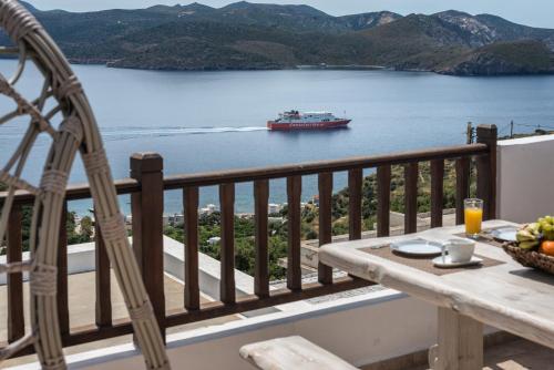 a boat in the water with a balcony with a table at Deluxe Sunrise in Tripiti