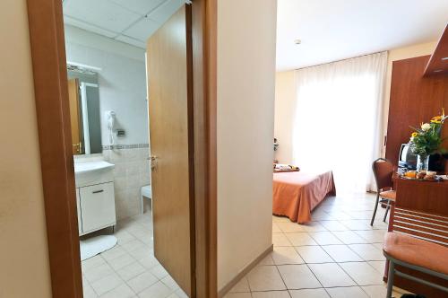 a bathroom with a toilet and a sink in a room at Hotel Priscilla in Rome