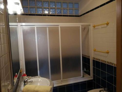 a bathroom with a shower with a sink and a toilet at THE POPPIES Guest House - 100m Ocean - Private Spaces in Candelaria