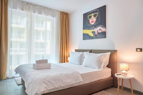 a bedroom with a bed and a large window at Fanta Sea Apartament Spa n Pool Beach resort in Mamaia Sat/Năvodari