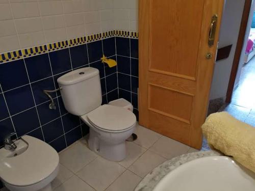 a bathroom with a toilet and a sink at THE POPPIES Guest House - 100m Ocean - Private Spaces in Candelaria