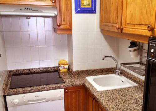 a small kitchen with a sink and a counter at Altea Cala Mascarat in Altea