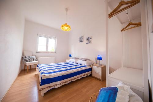 a bedroom with two beds and a window at Apartments Leonarda in Murter