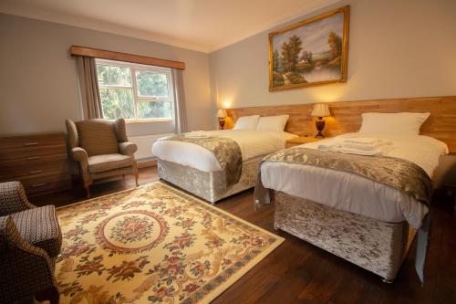 A bed or beds in a room at Westone Manor Hotel