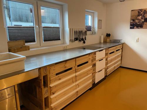 a large kitchen with wooden cabinets and a sink at Ferienhaus Tannenhof in Birgel