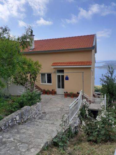 a house with a staircase leading up to it at Apartman Dani in Orebić
