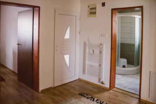 a room with a door and a bathroom at Golden House in Sarajevo