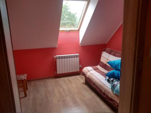 a living room with a couch and a window at Zacisze nad Rospudą in Filipów