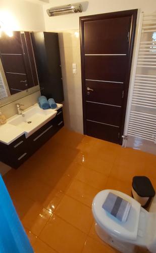 a bathroom with a toilet and a sink and a mirror at MARMARI Village in Ayía Marína