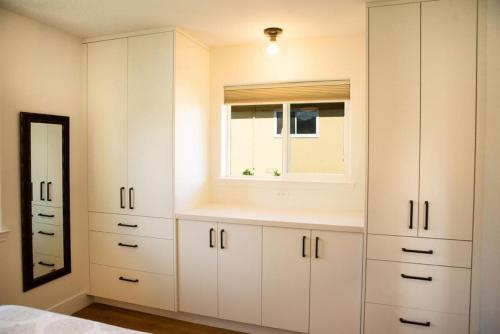 a bedroom with white cabinets and a mirror at 90 San Luis Street Unit D in Avila Beach