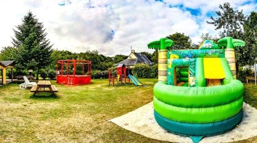 a playground with a inflatable play structure in a park at Camping Ty Nénez in Pont-Scorff