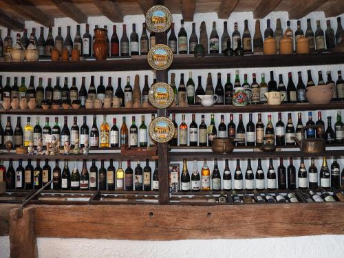 a bunch of bottles of wine on a wall at Agriturismo Sacchiafarm in Borgo Pace