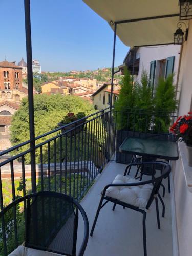 a balcony with two chairs and a table at Relais Colle San Pietro in Verona