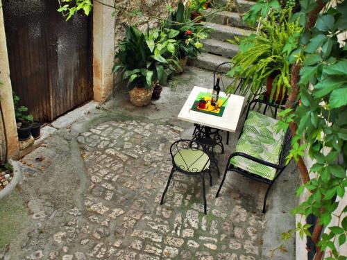 a table and two chairs with a cake on it at Rooms & Studio Stipcic in Trogir