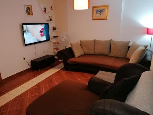 a living room with a couch and a flat screen tv at House Srima-Vodice Dalmatia in Srima