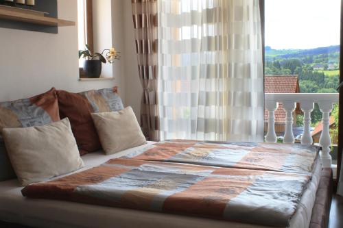 a bed sitting in a bedroom with a window at Villa Toscana in Steyr