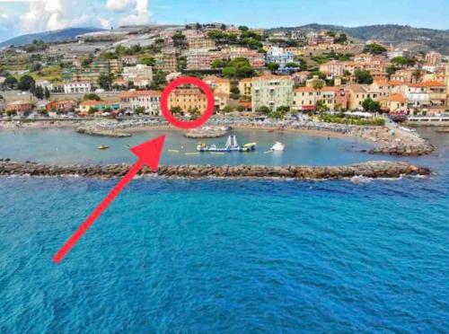 an island in the water with a red arrow at Casa Nanà in Santo Stefano al Mare