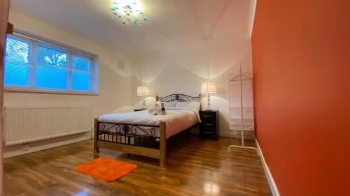 a bedroom with a bed with a cat sitting on it at Grand Heights Suites in London