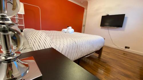 a bedroom with a bed with a teddy bear on it at Grand Heights Suites in London