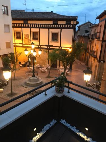 a view of a courtyard of a building with lights at Apartamentos La Herradura Terraza in Haro