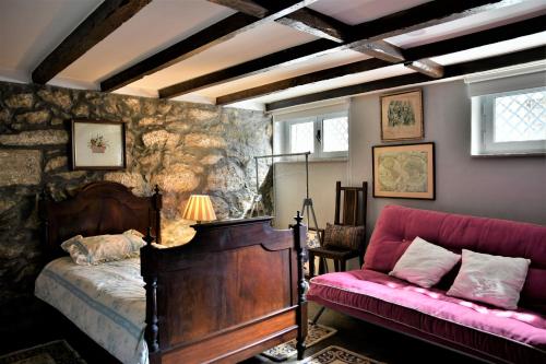 a bedroom with a bed and a couch at Casa do Moinho de Vento in Leça da Palmeira