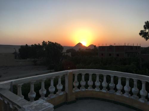 a sunset seen from the balcony of a building at Sakkara pyramid inn hotel in Cairo