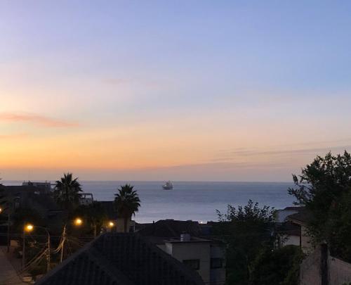 a ship in the ocean at sunset at Hostal Recreo in Viña del Mar