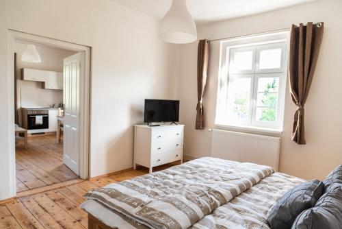 a bedroom with a bed and a window at Penzion U Pivovaru in Děčín