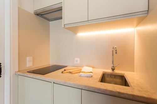 a kitchen with a sink and a counter top at Vila Costa in São Luis