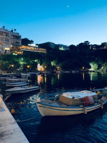 a group of boats docked in a harbor at night at Pension Mylos in Agios Nikolaos