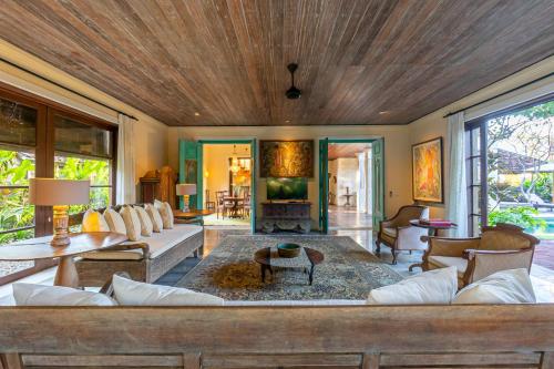 a living room with a couch and a table at Villa Angsa by Nakula in Sanur