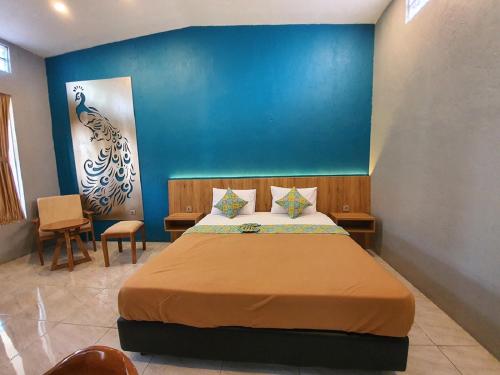 A bed or beds in a room at Sanur Agung Hotel