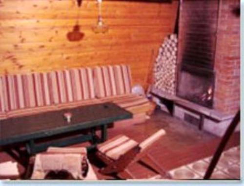 a living room with a couch and a fireplace at Chata pri potoku in Zuberec