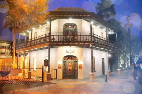 a large white building with a balcony on top of it at La Posada Hotel in Laredo