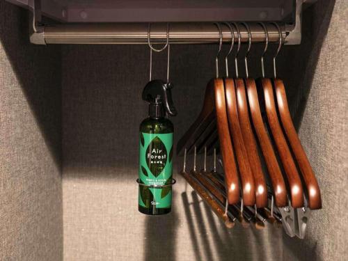 a bottle of alcohol next to a bunch of hot dogs at KOKO HOTEL Hidatakayama - formaly Hotel Wing Hida Takayama in Takayama