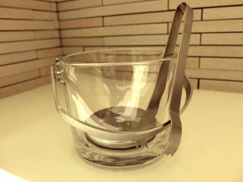 a glass cup with a spoon in it on a table at KOKO HOTEL Hidatakayama - formaly Hotel Wing Hida Takayama in Takayama