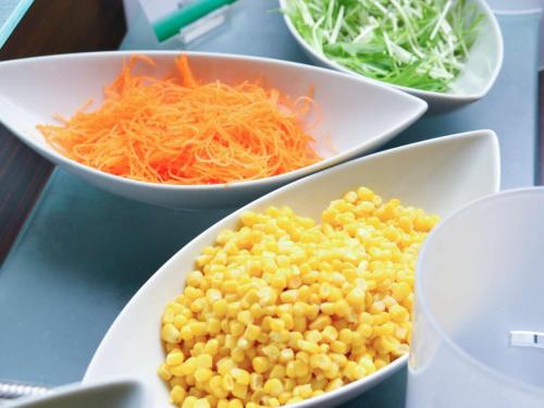 a table with three bowls of corn and carrots at KOKO HOTEL Hidatakayama - formaly Hotel Wing Hida Takayama in Takayama