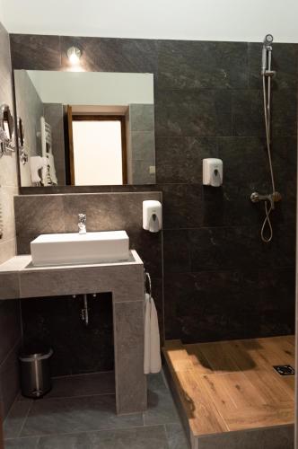 a bathroom with a sink and a mirror at Vén Diófa De Lux Panzió in Szeged