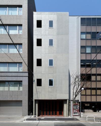 a tall concrete building with a lot of windows at BUNSHODO HOTEL in Fukuoka